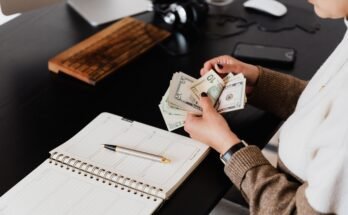 Woman counting freelance earnings from the Most Profitable Fiverr Services to Sell in 2026