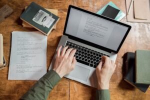 Freelance content writer working on a laptop, offering content writing as one of the Most Profitable Fiverr Services for online businesses.