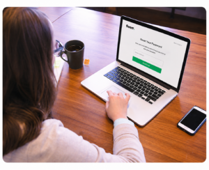 Freelancer resetting a Fiverr account password using a laptop