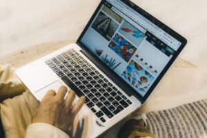 How to Become a Successful Fiverr Seller in 2026 – Freelancer using a laptop to research creative projects, explore the Fiverr marketplace, choose a profitable niche, and build a successful freelance business.
